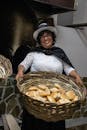 Smiling Woman Holding Basket with Bakery Products